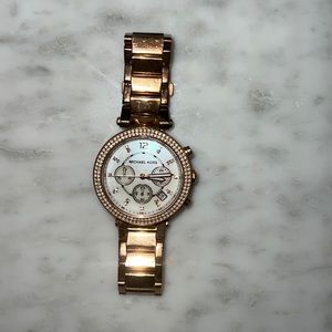 Rose gold Michael kors watch with white interface